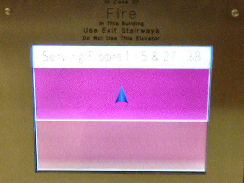 Two color blocks displayed on touch screen with up arrow in a dark pink square and an empty peachy pink block below.